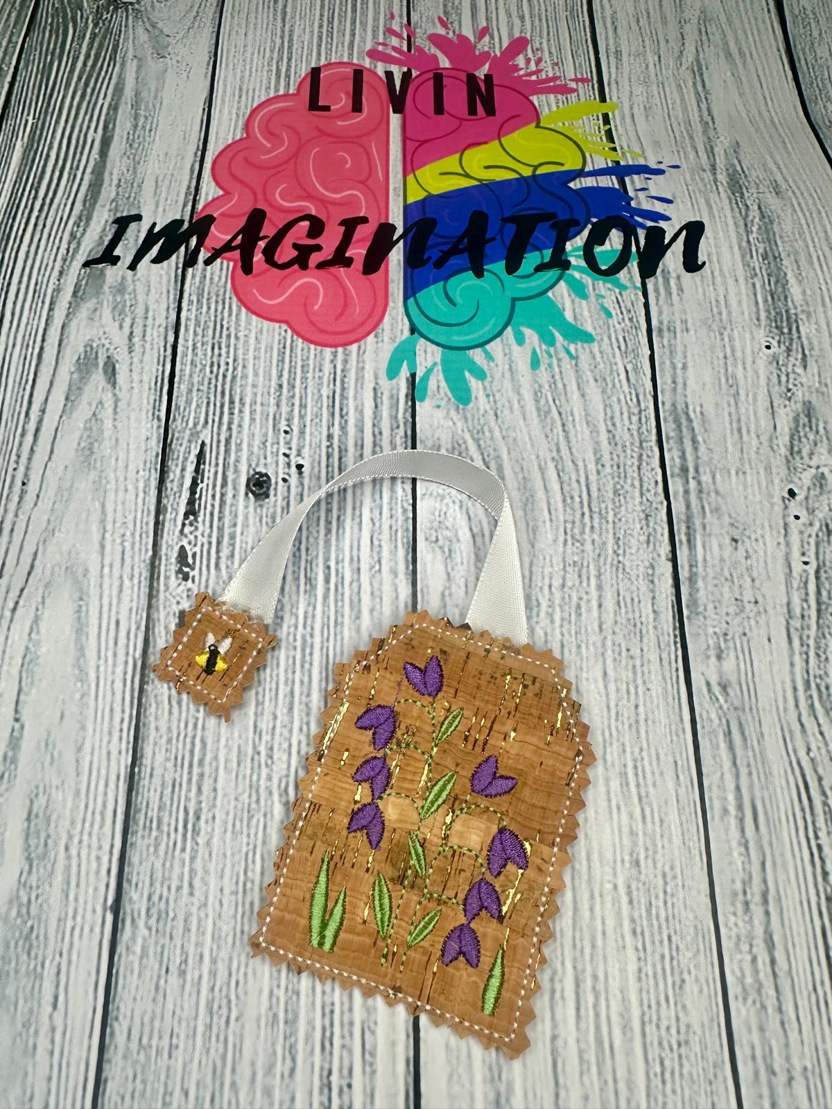 Decorative bookmark with floral design on cork fabric.